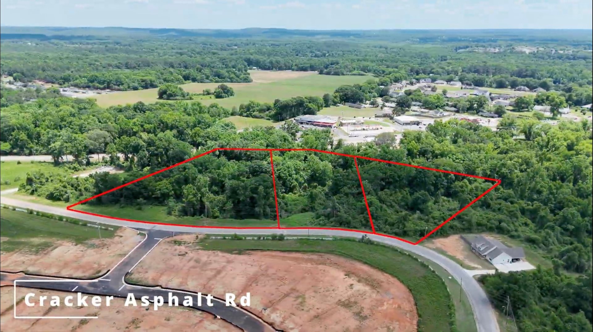 Aerial of Cherokee Bend Lots 333, 334 and 335 outlined along Cracker Asphalt Road in Moundville, Alabama