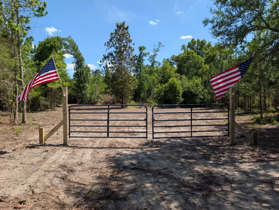 Gated entrance with paved frontage on Lovewood Road at Owl Crossing