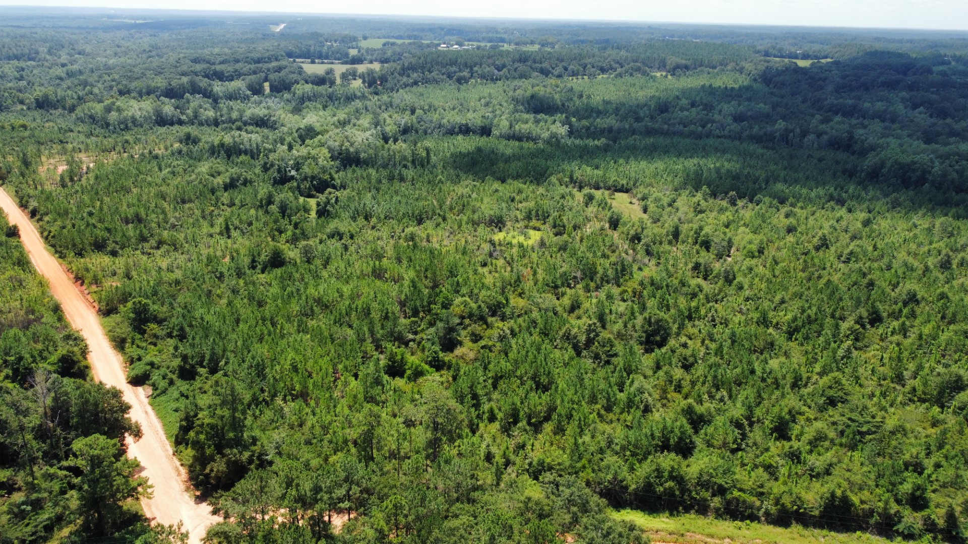 Aerial of a dirt county road running along the tract