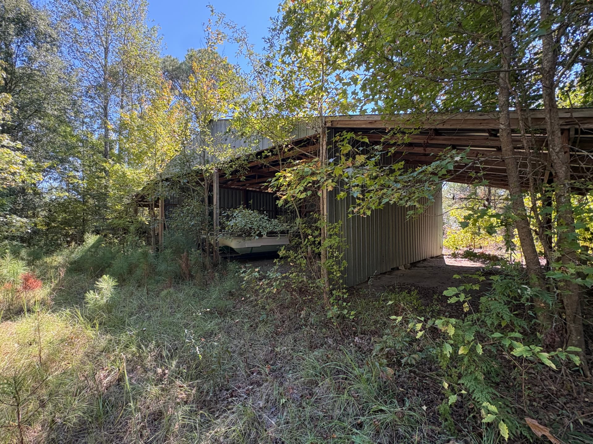 Three-bay open-sided metal shed on the property