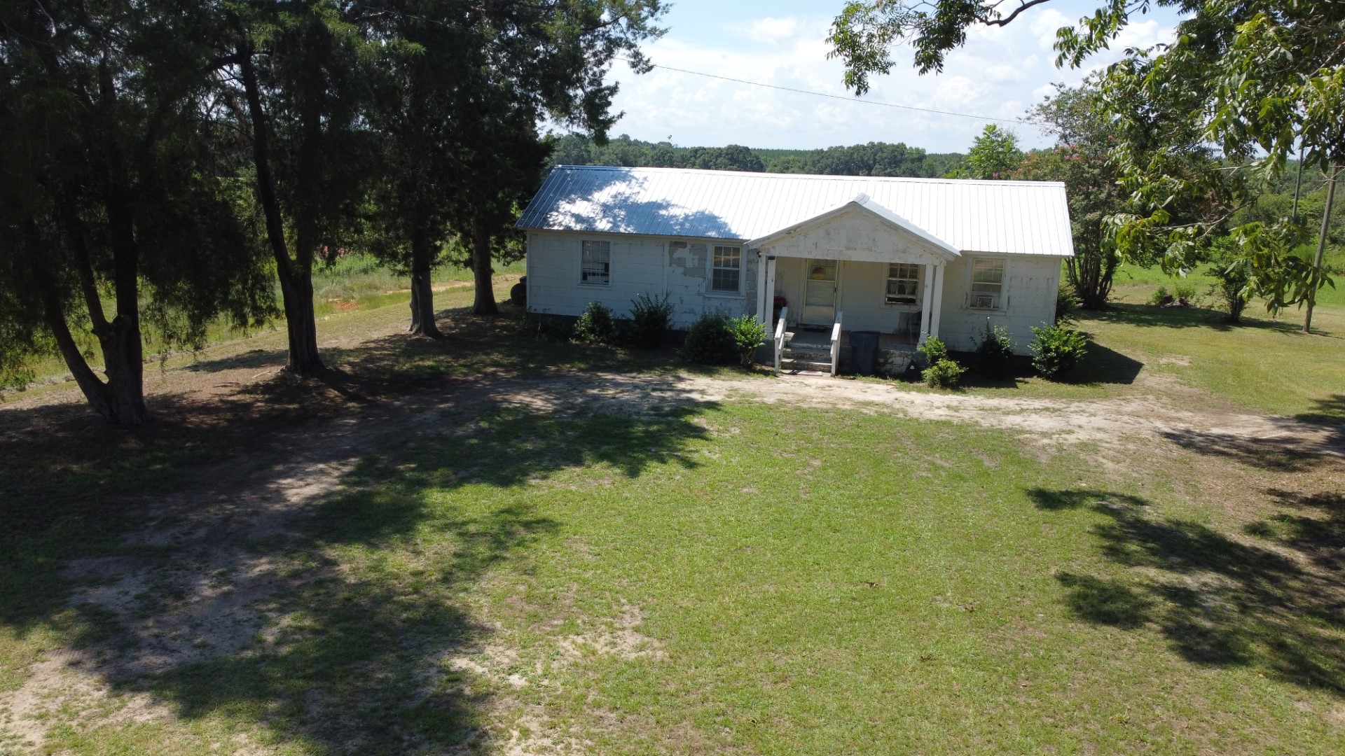 The residence and yard from above, framed by trees