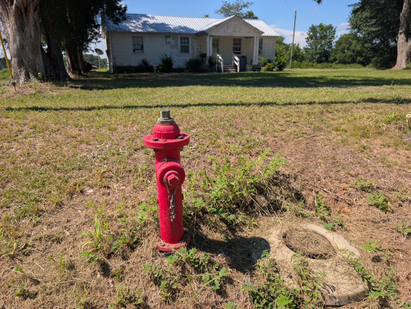 A fire hydrant in the yard near the residence