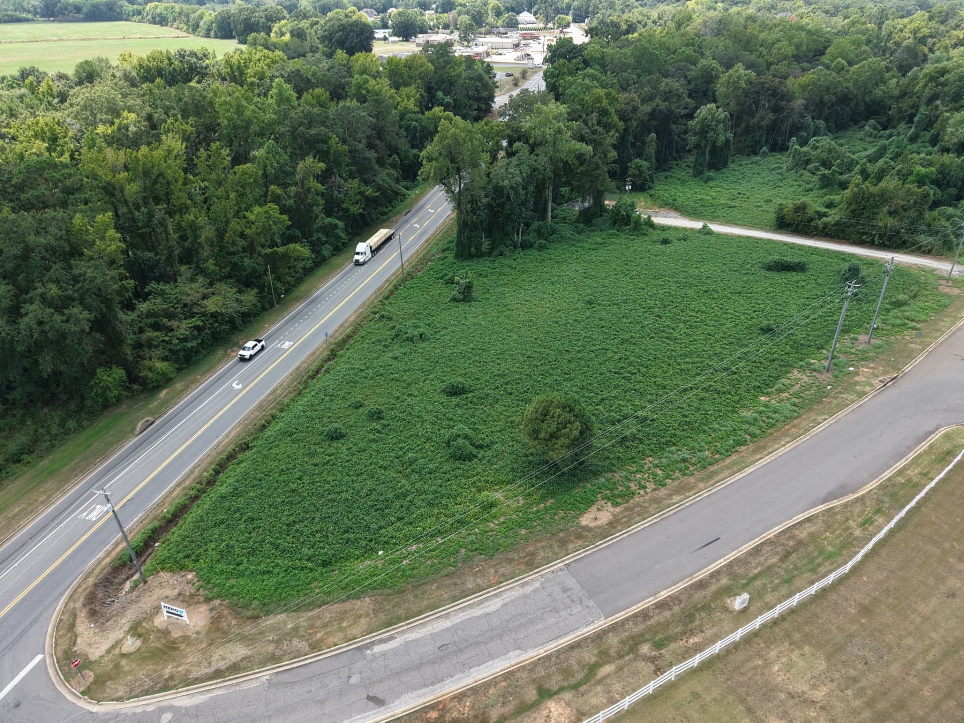 Aerial along Highway 69 showing the lot's frontage and open ground