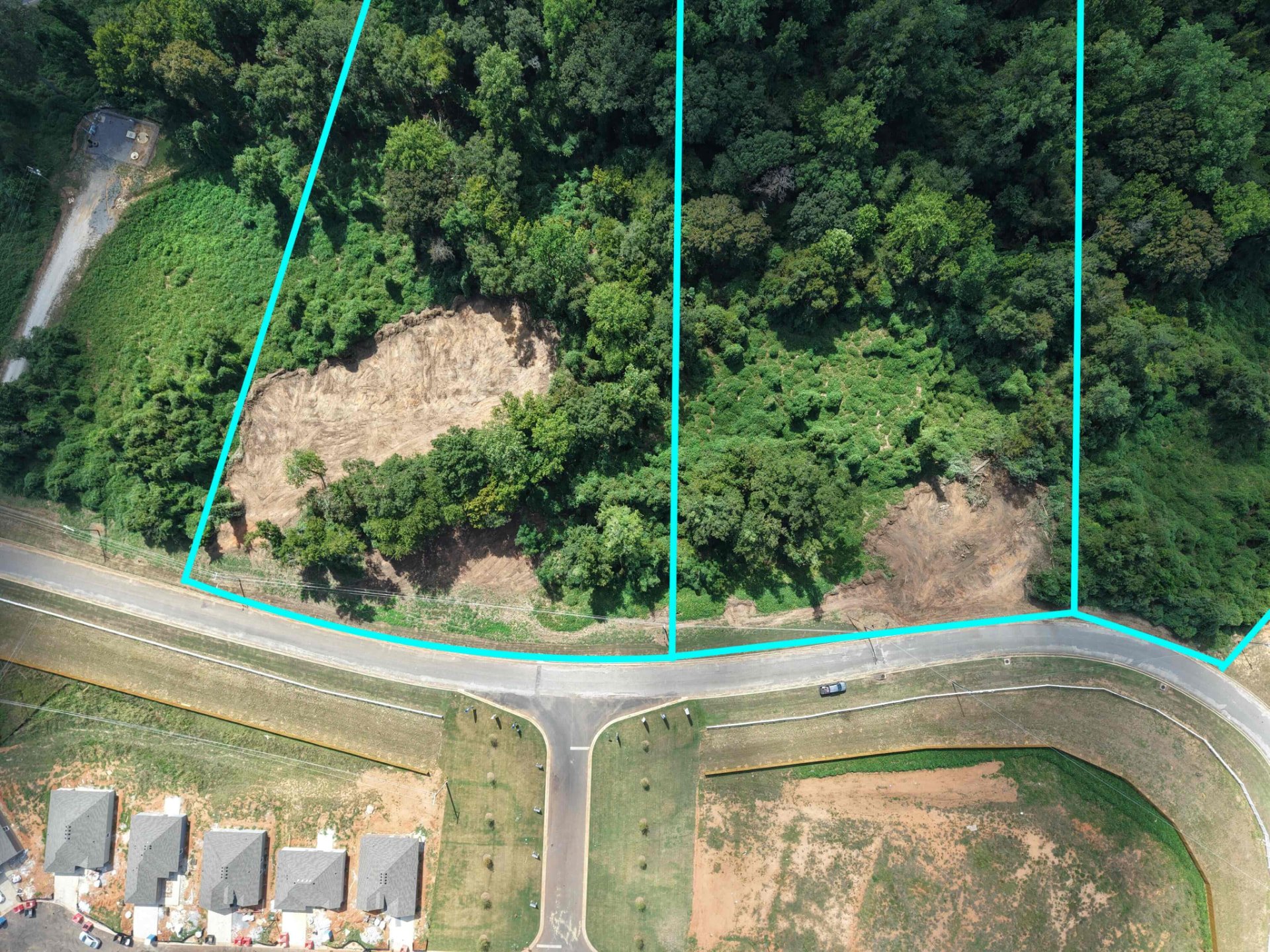 Close aerial of the wooded lots and road frontage