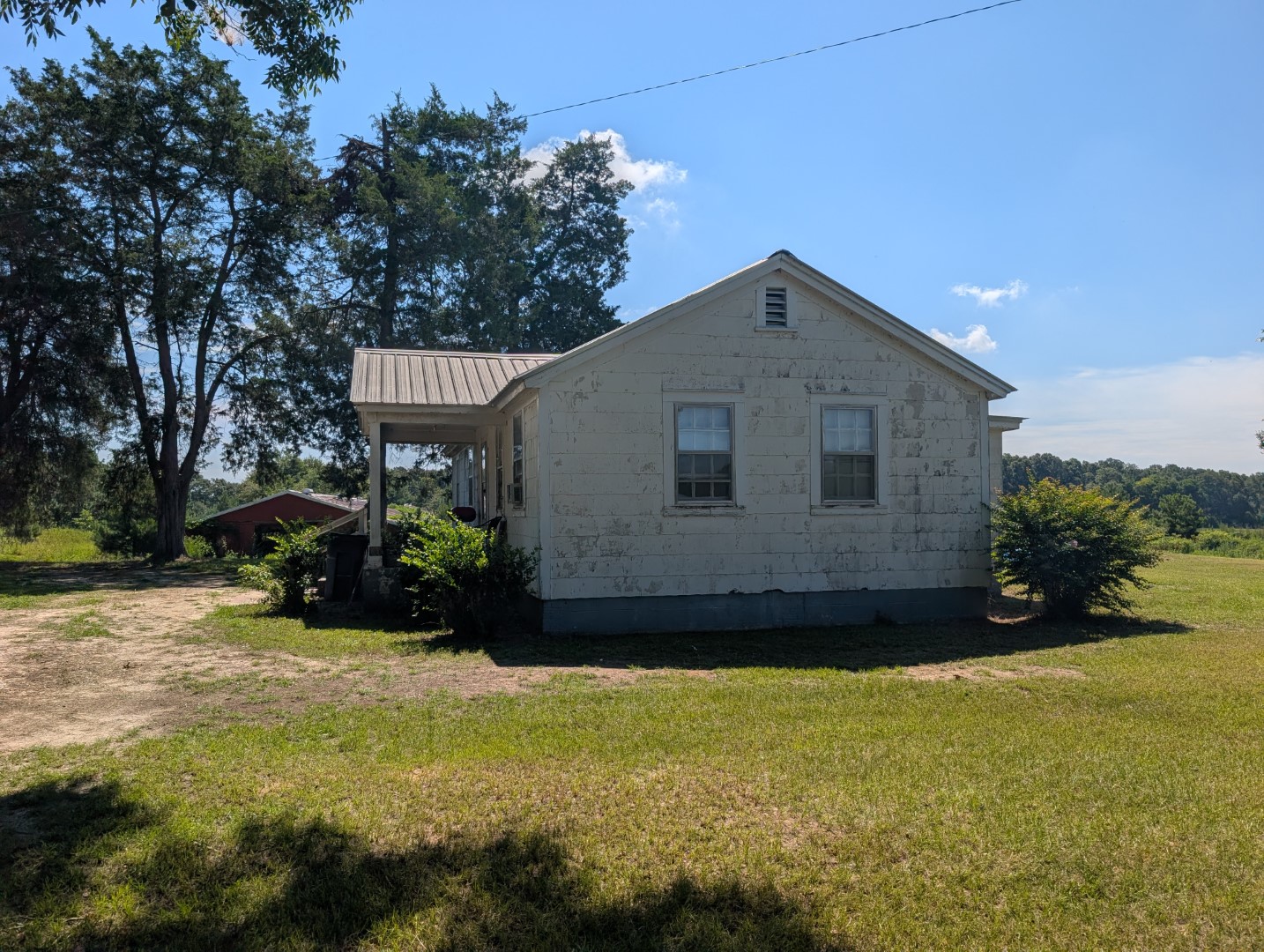 The side of the residence and the shop building beside it