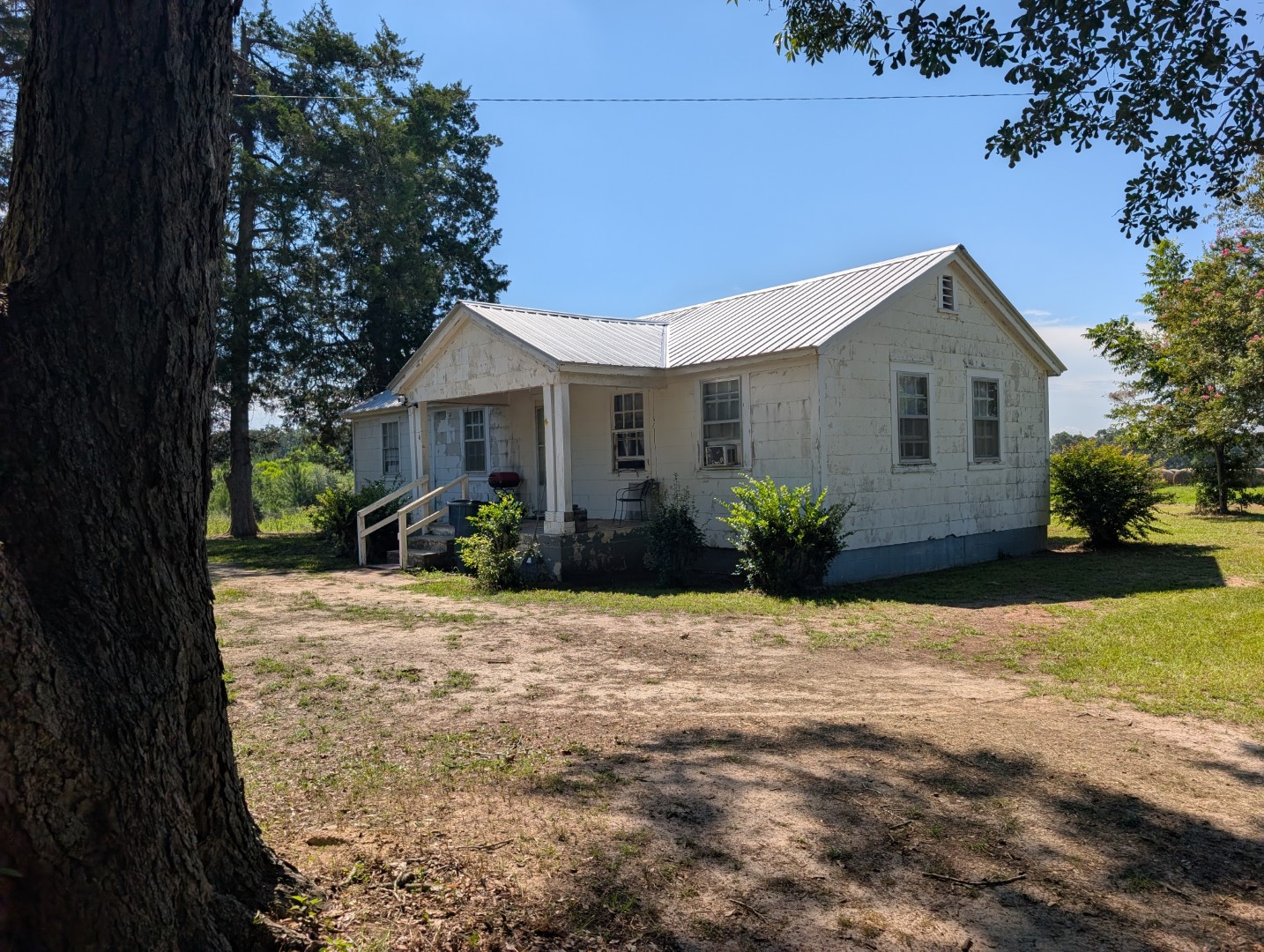 The residence and yard with timber behind