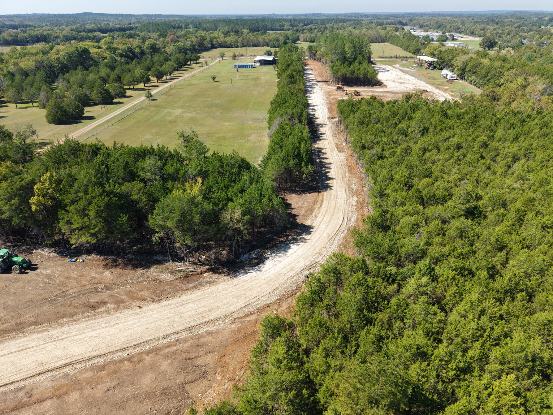 Aerial of the rock-base private driveway winding into the tract from the road