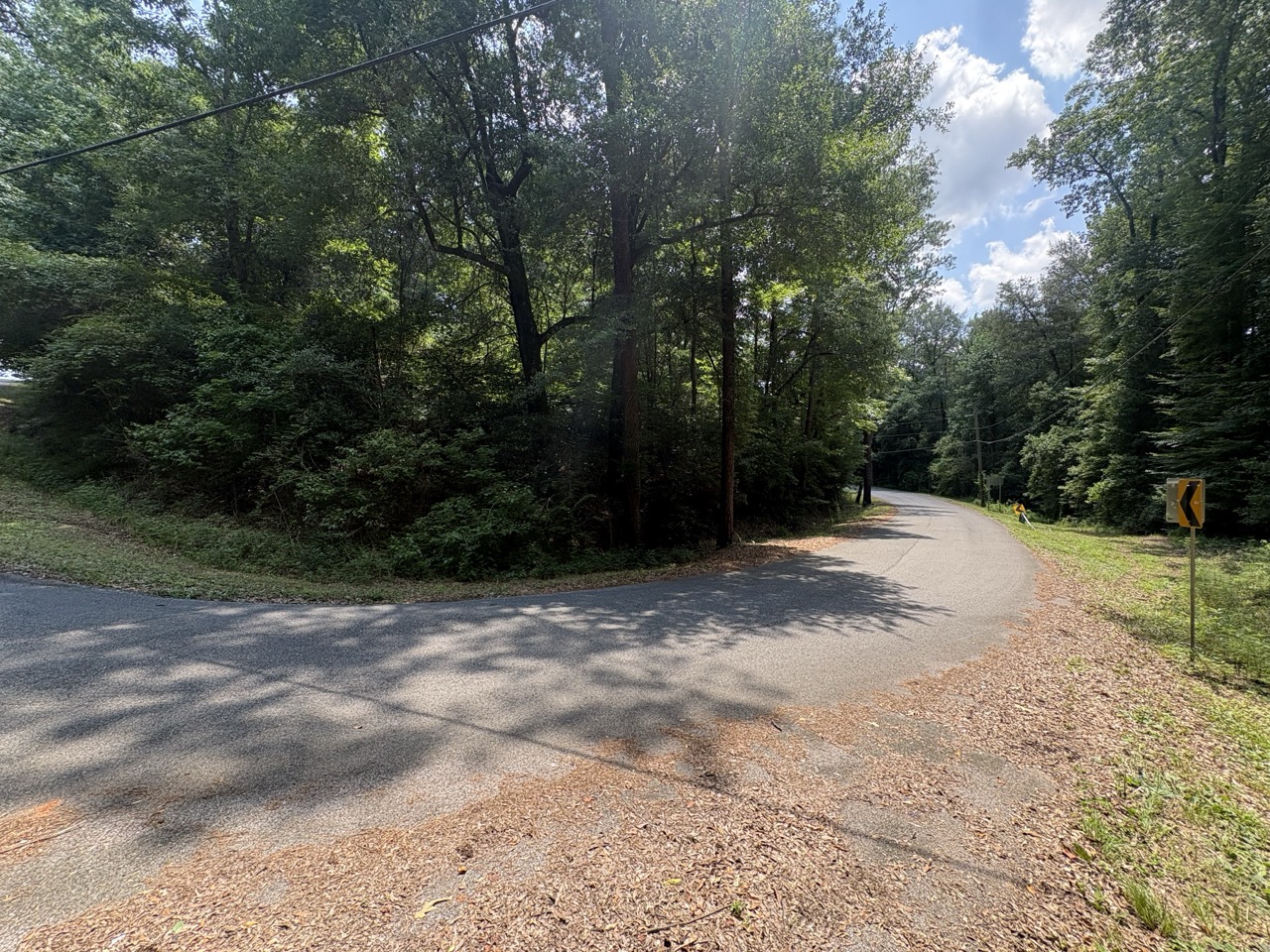 Road curve with warning sign at the Woodmont Lot 40 frontage