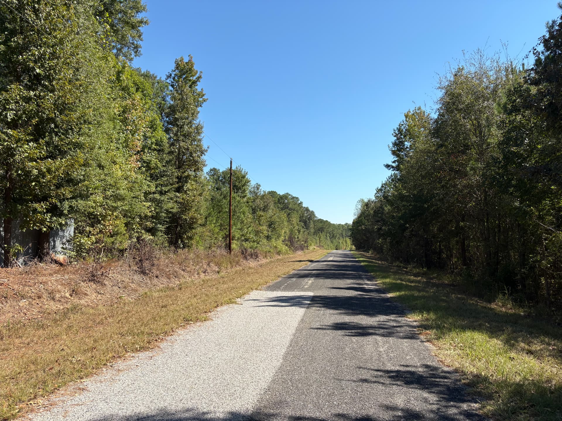 Paved County Road 38 frontage with power lines along the road